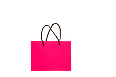 colored shopping bag on white. Paper pink bag isolated on white background. buyer's package. shopper bag. shopping concept. copy spaceの写真素材