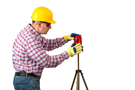 Builder man with laser level side view. measuring with laser level. Construction Worker Handyman on...