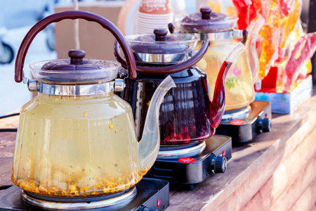 Glass Teapots. Row Kettles. Several teapots on electric stoves. The concept of tea drinking, hot, warming drinksの写真素材