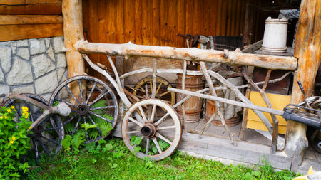 Vintage wooden cart wheels. Antiquarian transport. Old wooden two-wheeled cart, vehicleの写真素材