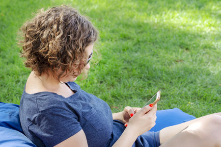 Girl with the smartphone.Woman standing and using smartphoneの写真素材