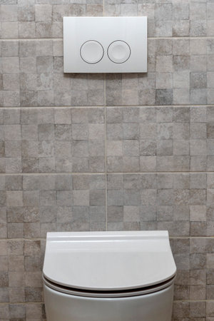 Toilet bowl button on the wall. Copy space. toilet with two separate buttons. Modern toilet design...