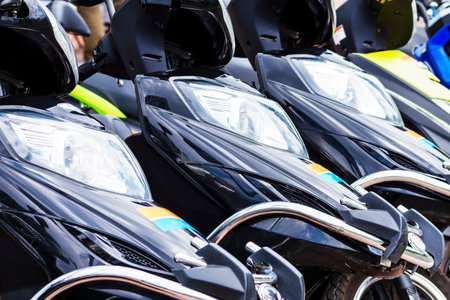 scooters parked. scooters on a city street.