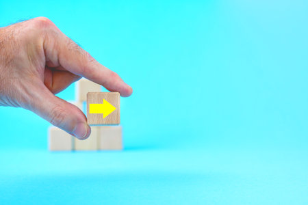 Hand. Wooden cube with arrow. Overcoming Problem Crisis and way to success concept. faithful or only...