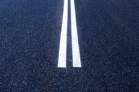 The asphalt road with white stripes. The highway with a white marking. Concept long way, beginning somethingの写真素材
