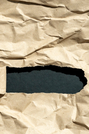 hole in paper with color paper background inside. Good paper texture.torn hole in paper.paper ripped to create a holeの写真素材