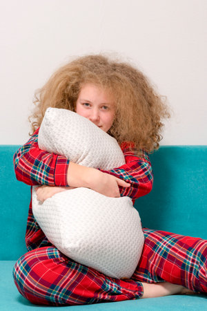 Girl hugging with a pillow. attractive, pretty Girl holding a pillow. Concept of a good, sound sleep. Time to sleep.の写真素材