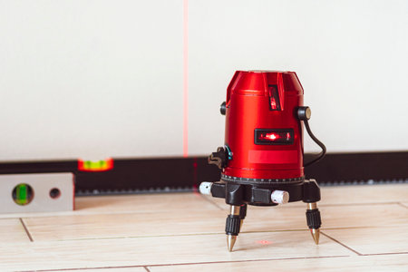 Laser level and Bubble levels, lines on the wall. measuring with red laser level.Measurement accuracy concept, modern measurement devicesの写真素材