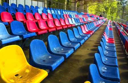 Stands. colored seats at stadium. Tribune of fans at the sports ground.Side viewの写真素材
