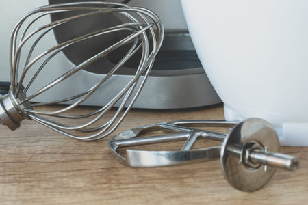 An overhead view of different metal mixing tools and components for a modern domestic kitchen...