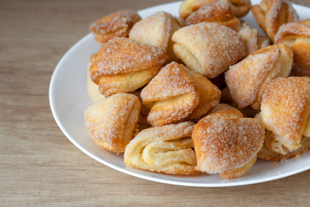 A top-down view of golden-brown homemade cookies served on a stylish plate, perfect for a snack.