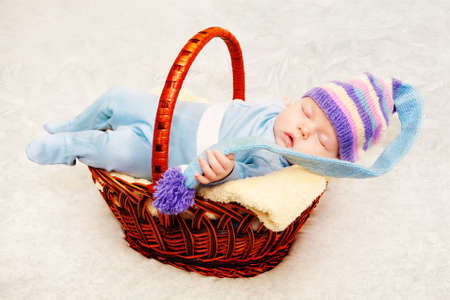 Newborn baby in blue knitted cap