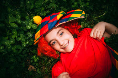 smiling little girl in clown wig