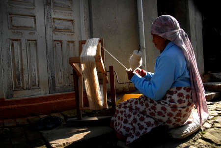 A woman spins wool thread at Khokana in Lalitpur on Thursday. Sheep wool is highly demanded during the winter season to knit different kinds of clothing to stay warm.のeditorial素材