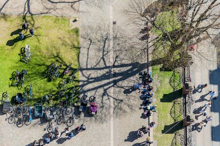 Photo of a group of people and parked bycicles in the park taken from above.のeditorial素材