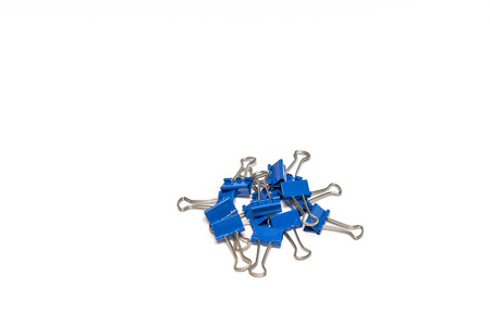 A bunch of blue binder clips isolated on whiteの写真素材