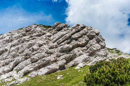 Layered rock formation on the top of mt Vogel, Slovenia, Europe. In the hot summer days against blue sky.の写真素材