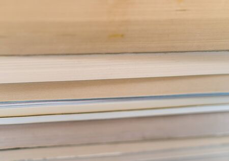 A close up of a couple of old books in a pile.の写真素材
