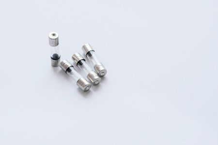 Electric fuses were destroyed in a glass capsule, white background.の写真素材