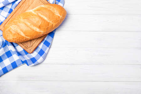 Fresh bread with napkin on kitchen tableの写真素材