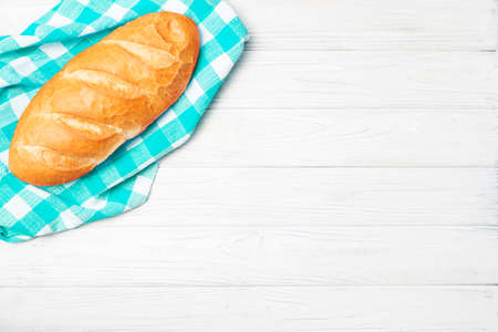 Fresh bread with napkin on kitchen tableの写真素材