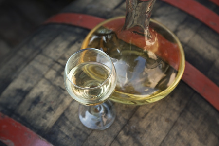 Bottle of wine with wine glass on the runlet. White wine.の写真素材