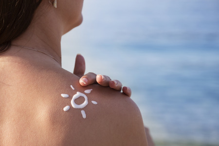 young,  beautiful woman sunbathing on summer day in the beach.