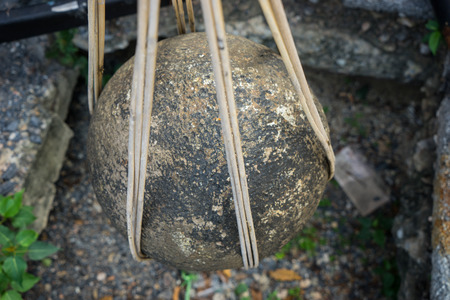 round stones buried in the ground to mark the sacred limits of a templeの写真素材