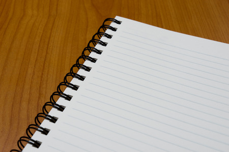 notebook paper on wood background