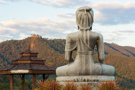 Sitting Buddha statue at the mountain in Thailandの写真素材