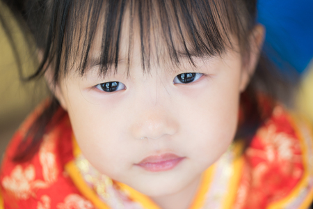 Cute Asian little girl wearing red traditional Chinese suitの写真素材