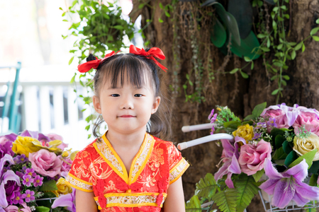 Cute Asian little girl wearing red traditional Chinese suitの写真素材