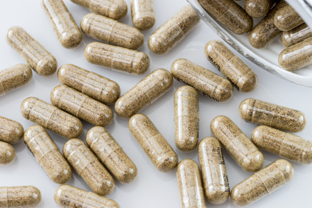 herb capsules on white backgroundの写真素材
