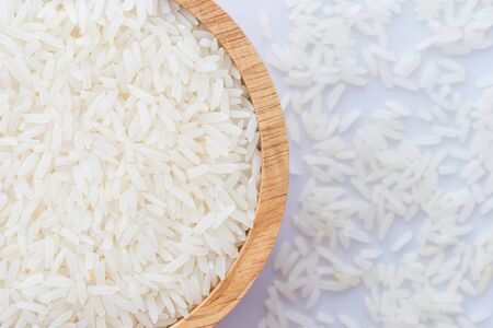 close up wooden bowl of jasmine rice grainの写真素材