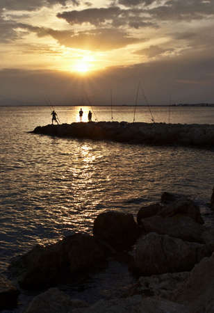 Fishing in Santa pola on a sunsetの写真素材