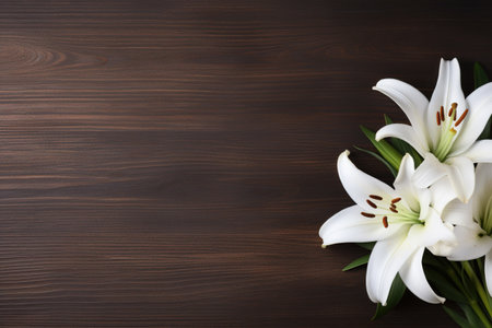 White lily flowers on wooden background. Top view with copy spaceの素材