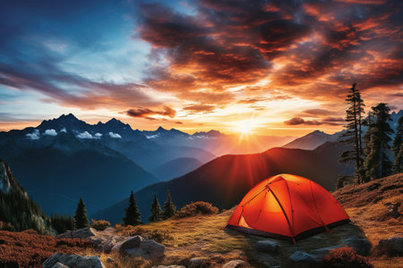 Camping in the mountains at sunset. The concept of active tourismの素材