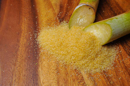 brow sugar and sugar cane on wooden backgroundの写真素材