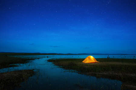 orange tent under starlight in camping trip weekend holidayの写真素材