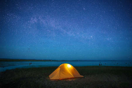 orange tent under starlight in camping trip weekend holidayの写真素材
