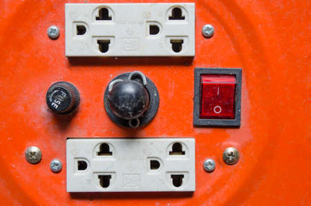 four plug socket in orange matal background with swicth for 220v