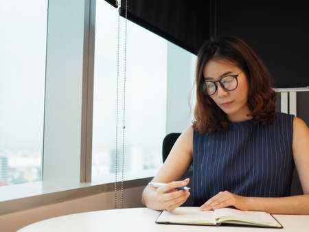 Working woman writing note in her desk