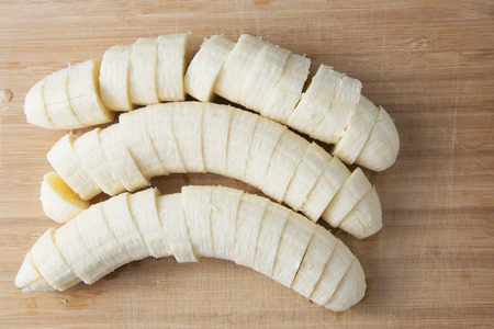 sliced banana on wood backgroundの写真素材