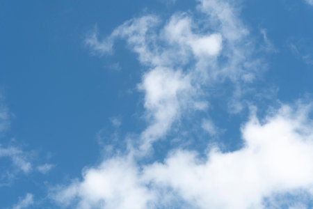 Blue sky background with white cloudsの写真素材
