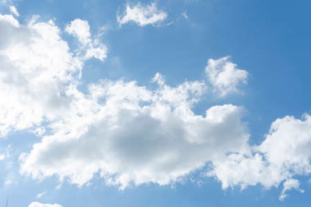 Blue sky background with white cloudsの写真素材