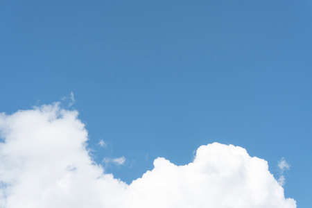 Blue sky background with white cloudsの写真素材
