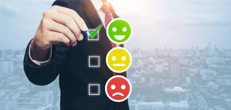 Customer Satisfaction survey concept.Business man check green smile faceの写真素材