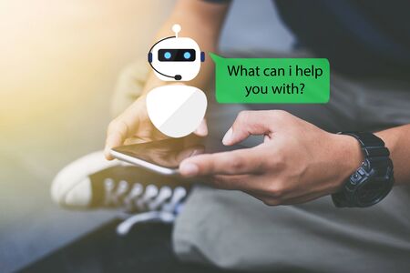 artificial intelligence,AI chat bot concept.Close-up of man hands using mobile phoneの写真素材