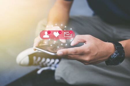 Social media network concept.Close-up of man hands using mobile phoneの写真素材