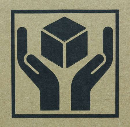 Fine image close-up of grunge black fragile symbol on cardboard の写真素材